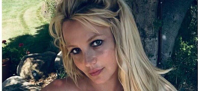 Britney Spears looking at the camera with a closed lip smile