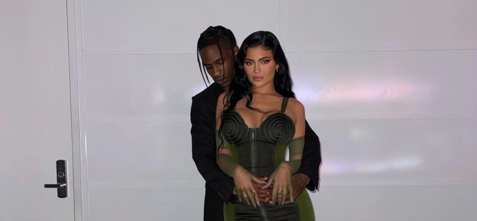 Travis Scott with his arms wrapped around Kylie Jenner
