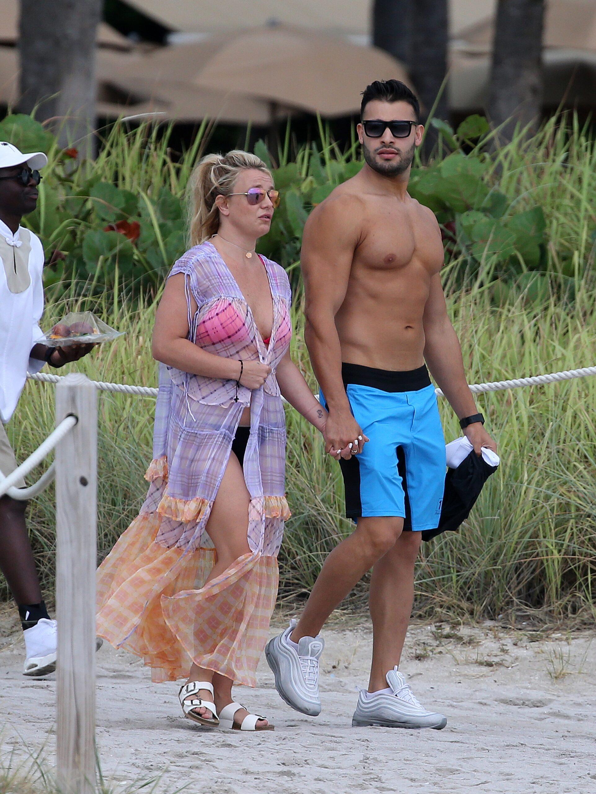 Britney Spears wears a pink bikini as she takes a jet ski ride with boyfriend Sam Asghari on the beach in Miami