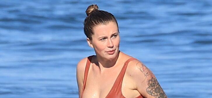 Ireland Baldwin shows off her curves in a one piece on the beach