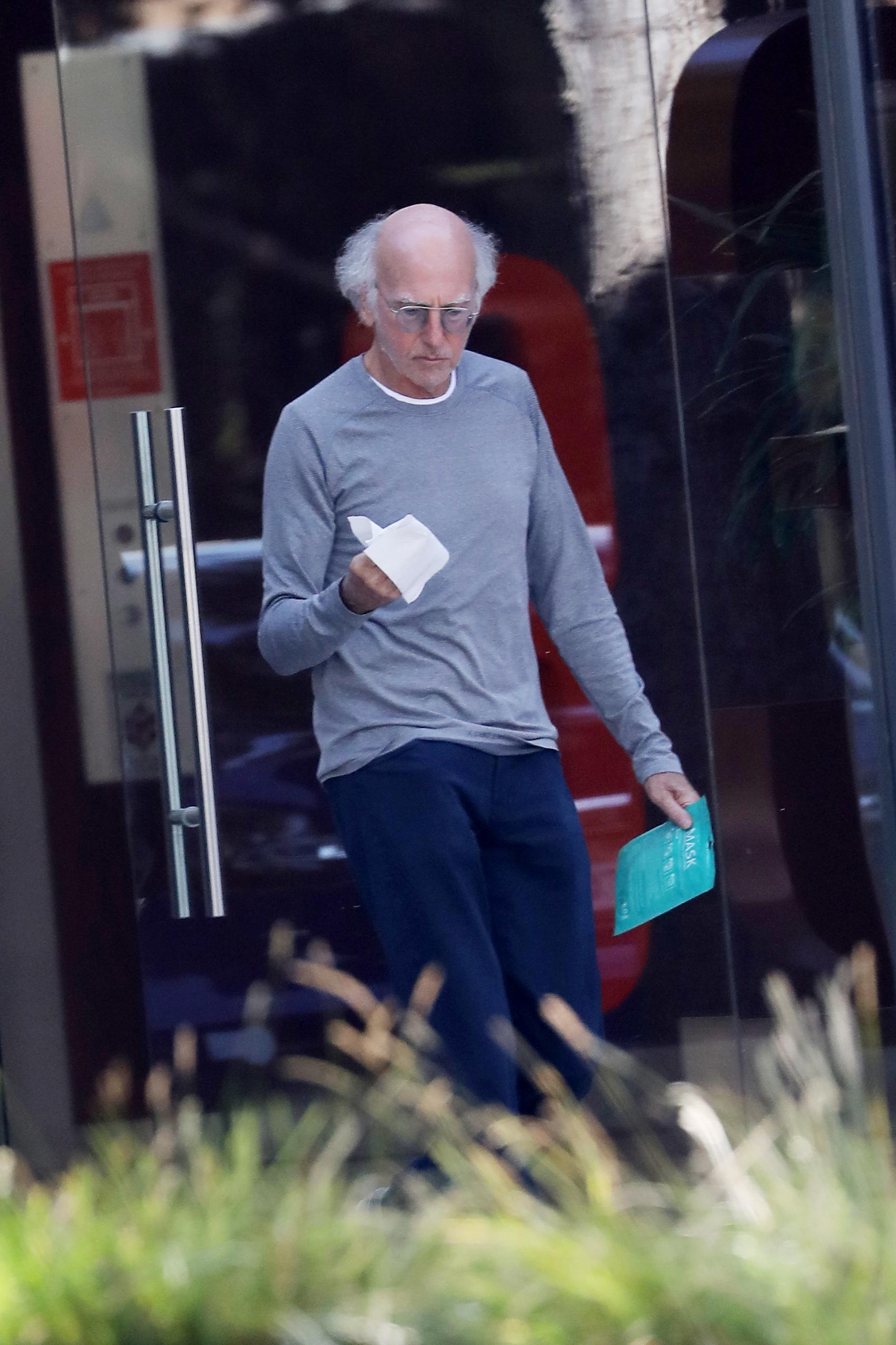 Newly wed Larry David coming out of an office building