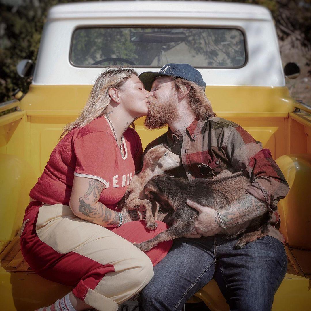 A photo showing Elle King and her fiancé Dan Tooker kissing in the back of a truck.