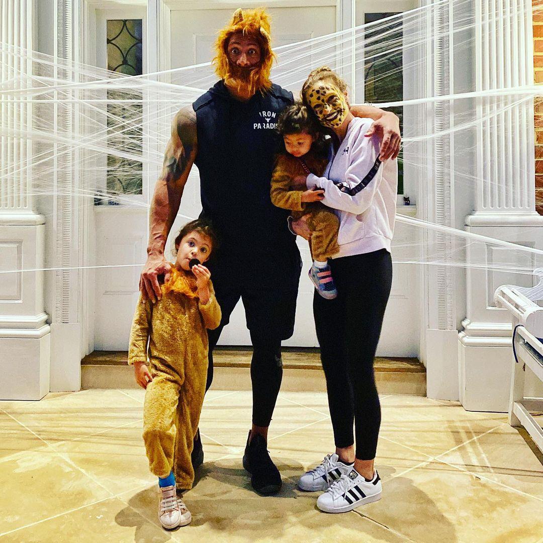 A beautiful family portrait showing Dwayne Johnson, Lauren Hashian, and their two kids, all disguised in lion outfits.