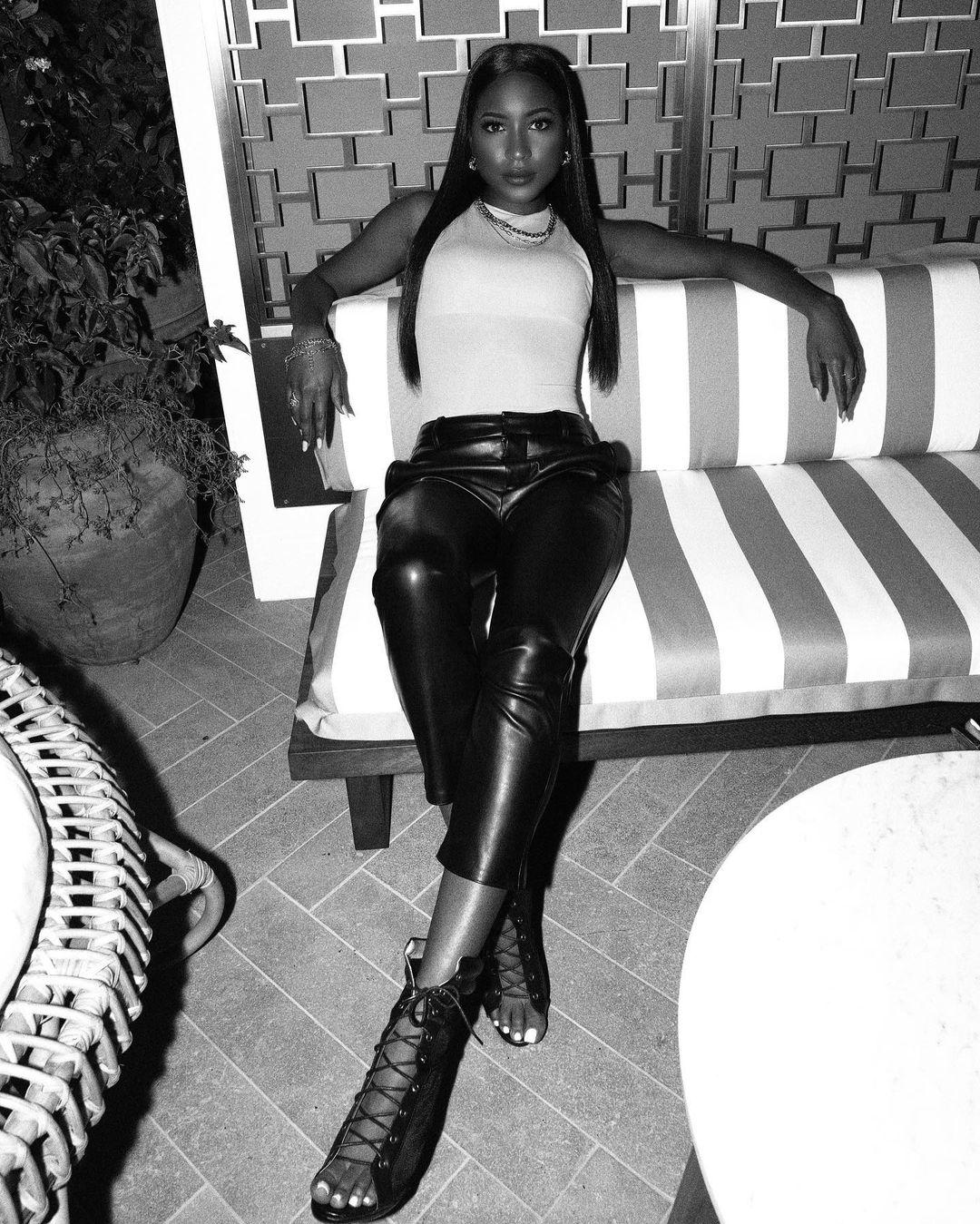 A black and white themed photo showing Carlacia Grant in a black and white outfit.