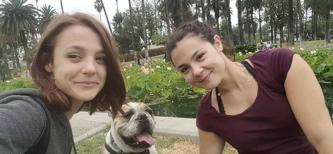 A photo showing Kathryn Prescott sharing a selfie with her sister and her furry friend.