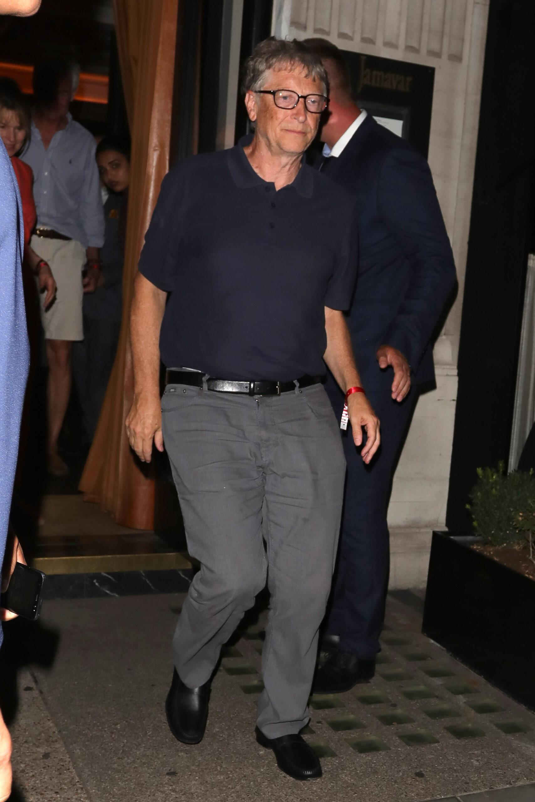 Microsoft Founder Bill Gates stumbles on a step as he leaves Jamavar in Mayfair after dining with friends