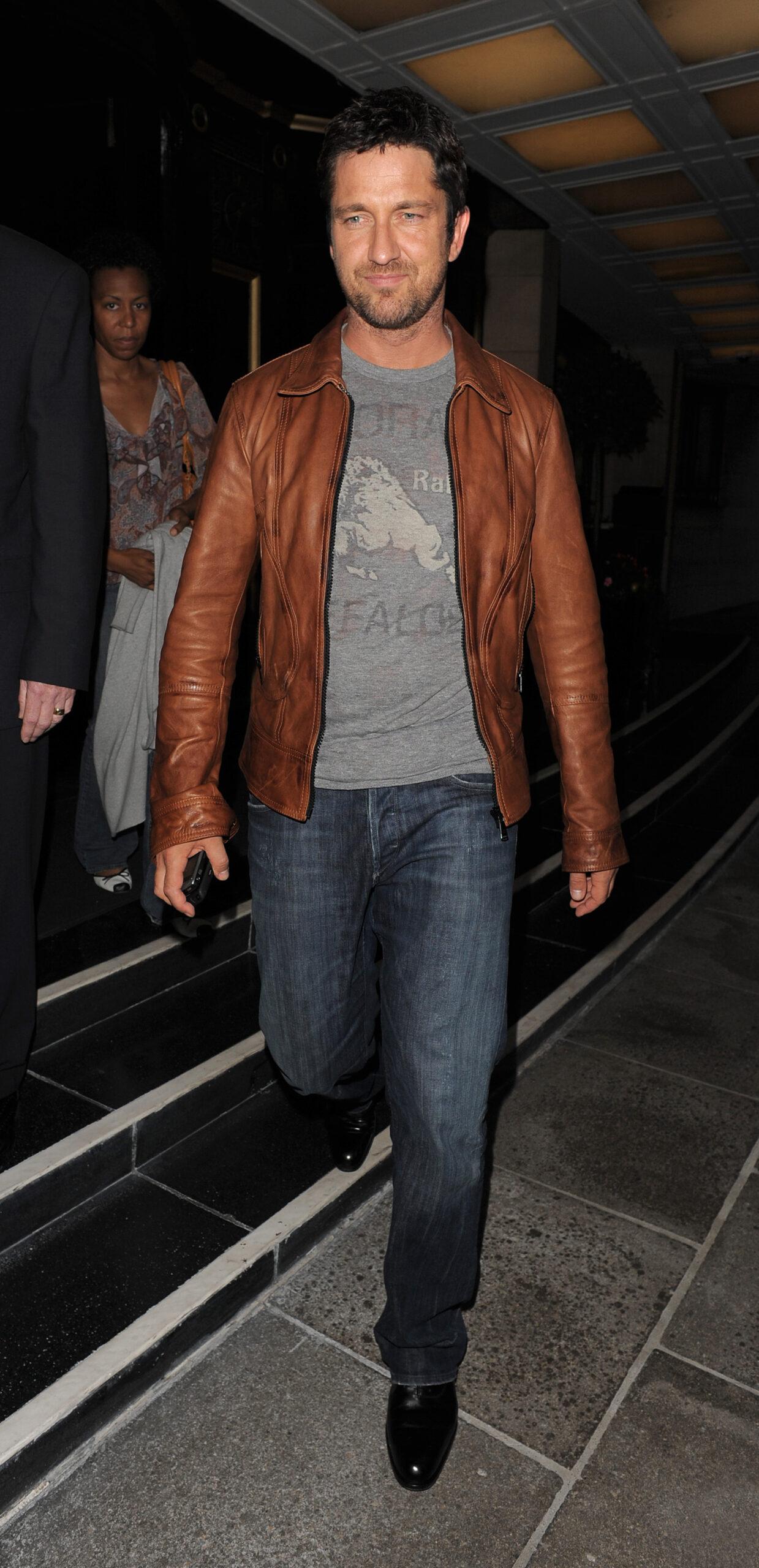 Gerard Butler leaving his hotel to go for dinner at Hakkasan restaurant He spent around two hours inside and wore a brown leather jacket grey t-shirt and jeans for the low key outing