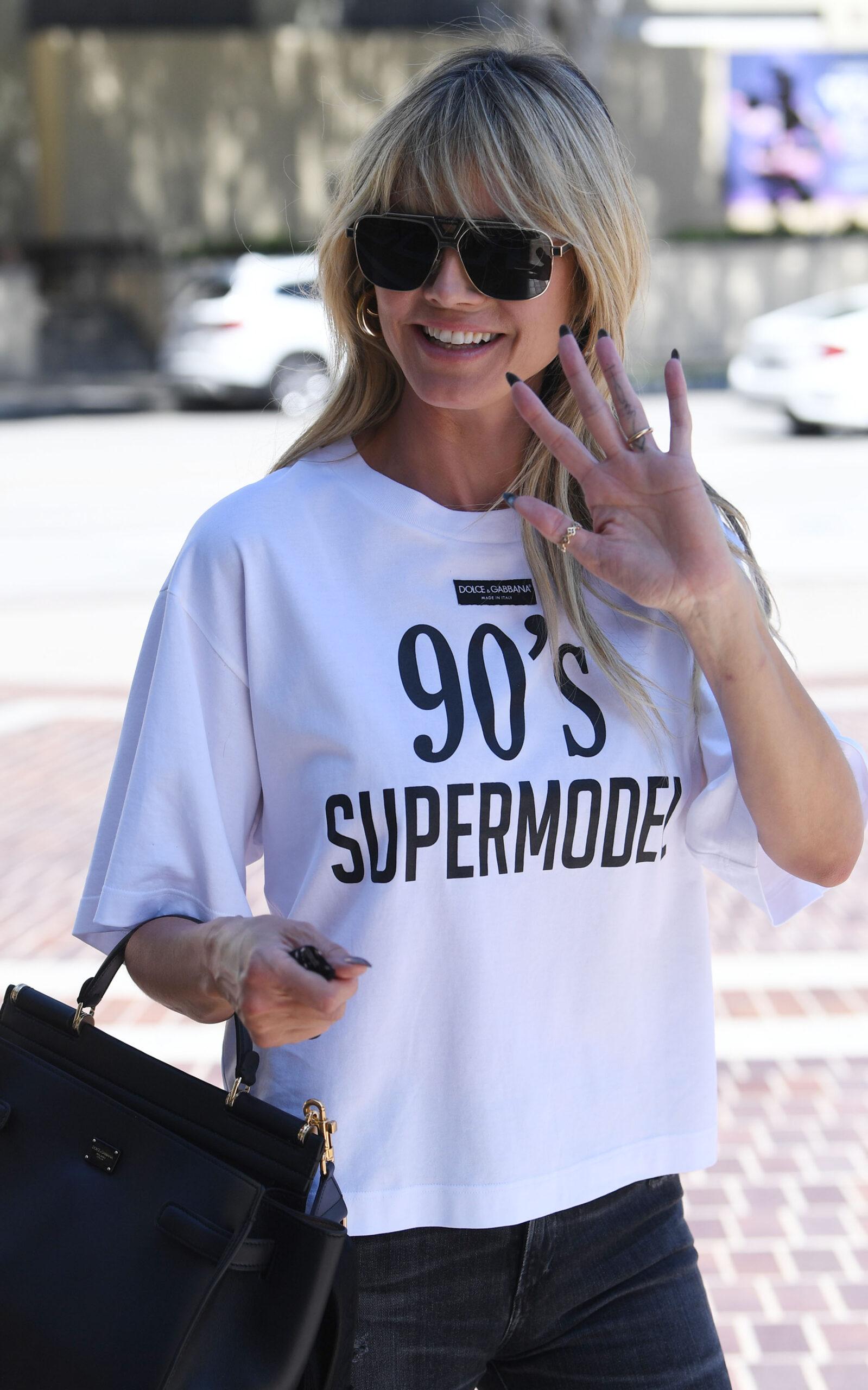 Heidi Klum flashes a peace sign while heading back to work on America apos s Got Talent in a 90 apos s Super Model T-shirt