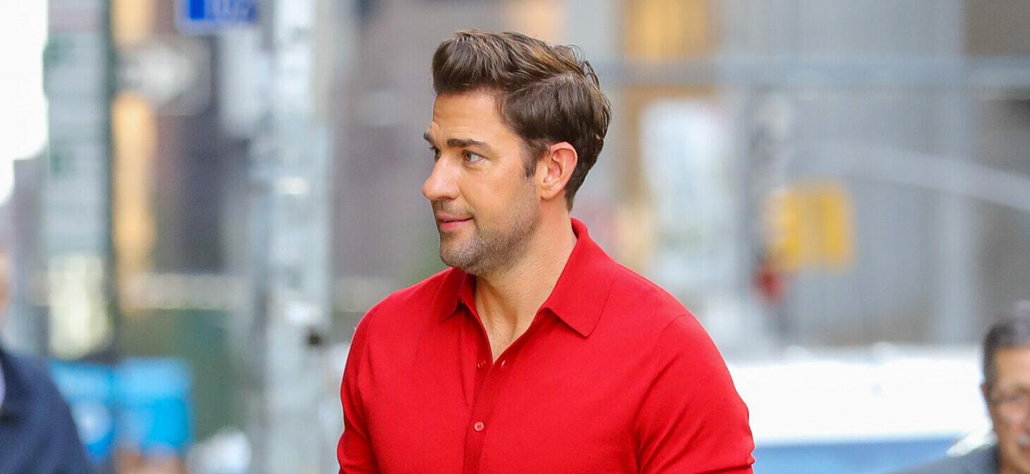 John Krasinski seen wearing a red shirt and a purple socks while arrives at The Late Show with Stephen Colbert