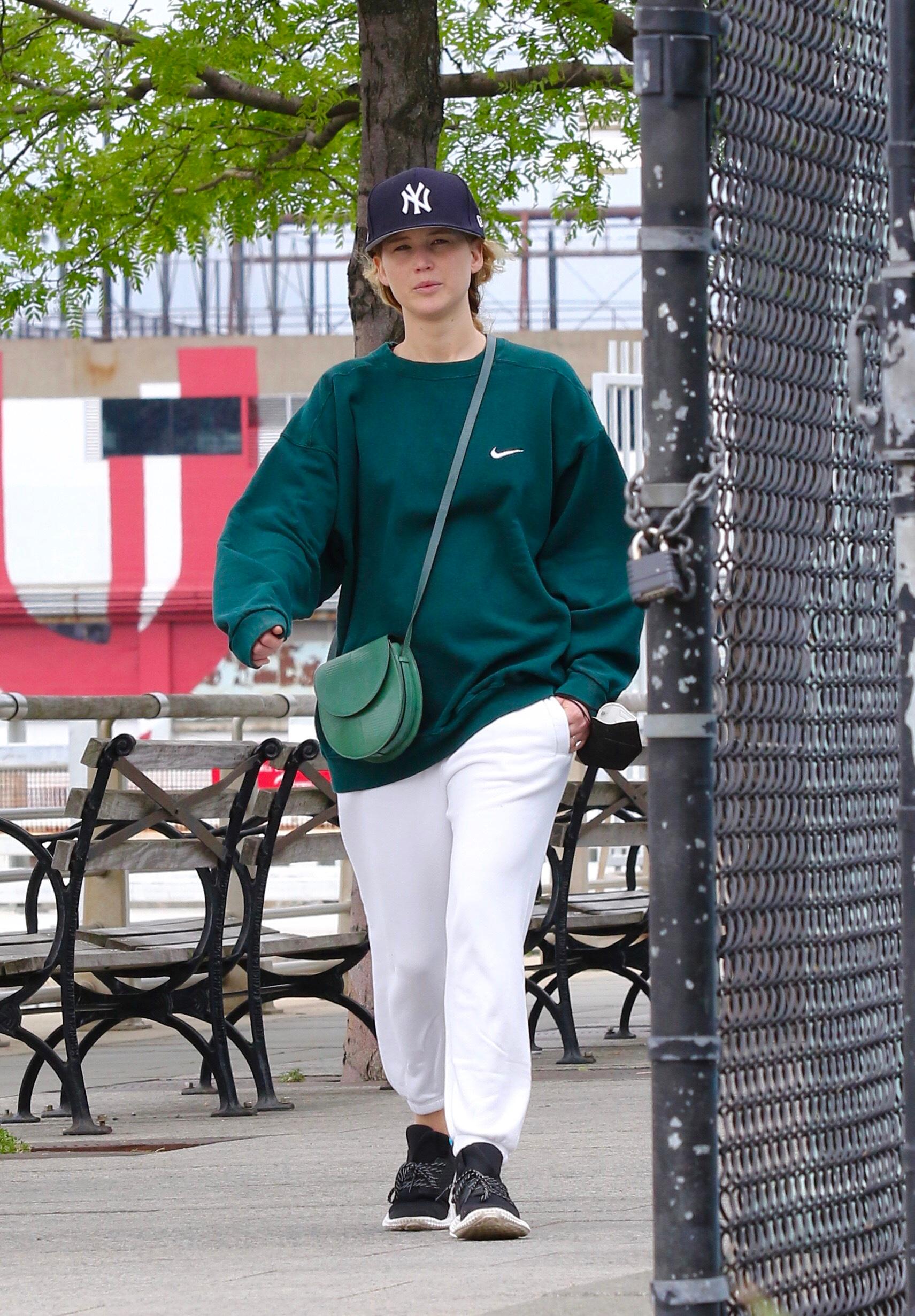 Jennifer Lawrence in sweats goes on a power walk with husband Cooke Maroney in Hudson River Park NYC