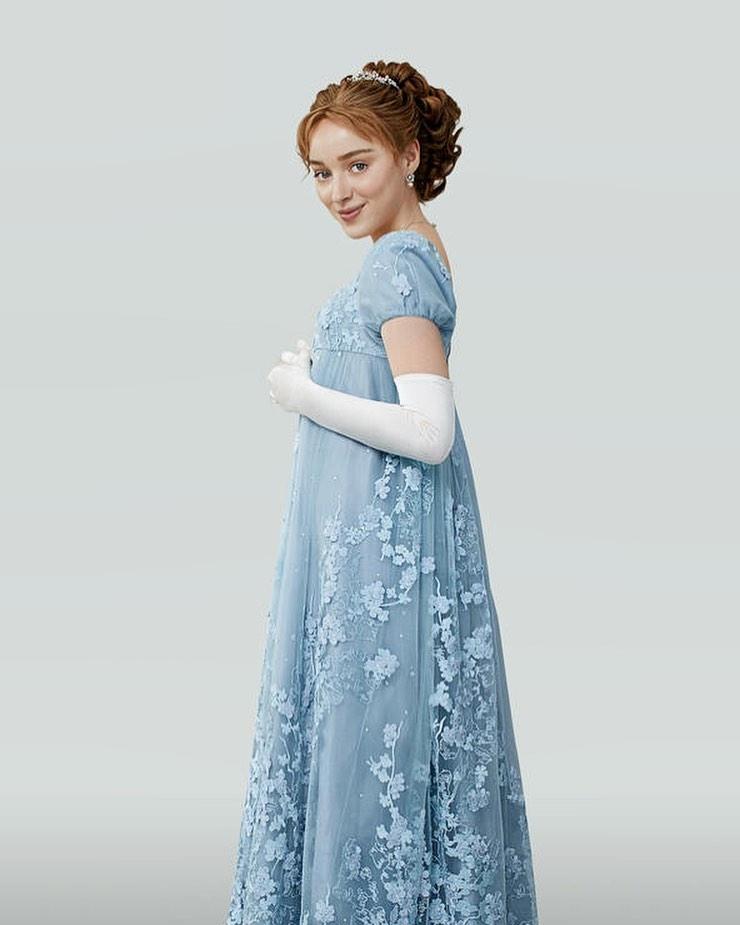 A photo showing Phoebe Dynevor in a long blue dress.