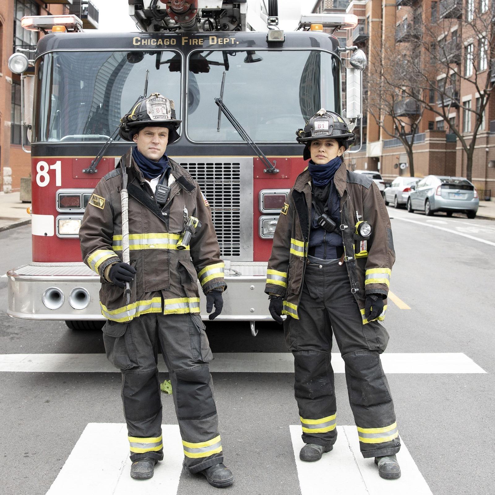 A photo showing Jesse Spencer and his co-star standing in front of a firetruck.