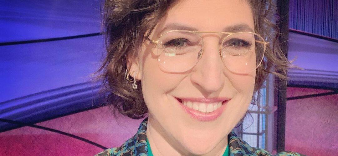 Mayim Bialik takes a selfie on the "Jeopardy!" stage.