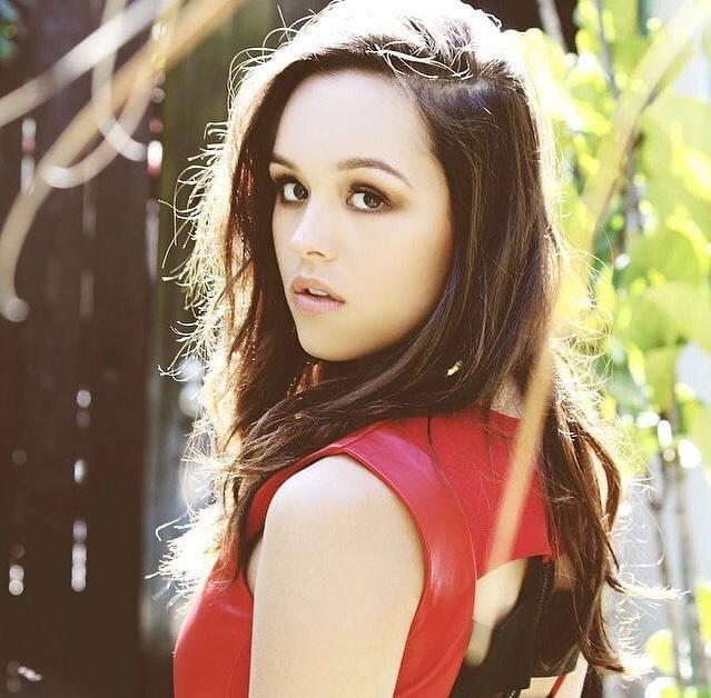 A photo of Hayley Orrantia in a red dress, looking amazing.