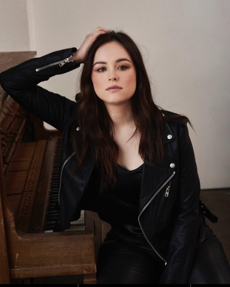 A photo showing Hayley Orrantia sporting a black jacket.