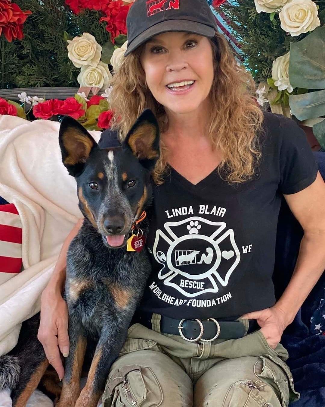 A photo showing Linda Blair posing with her dog.