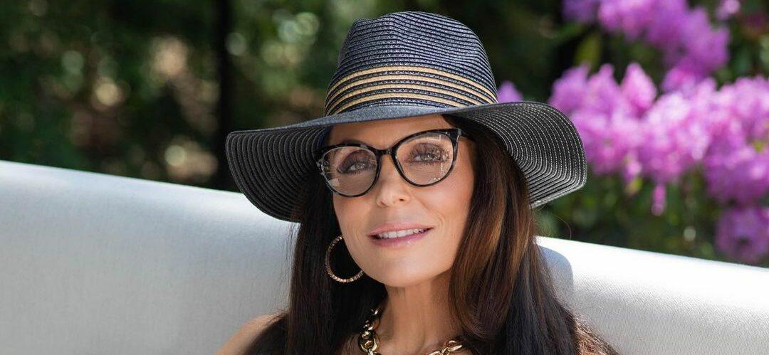 A photo showing Bethenny Frankel wearing a hat and transparent-lend glasses.