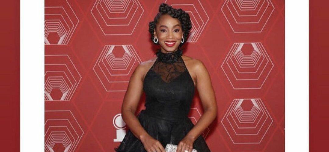 A photo showing Anika Noni Rose in a black ball dress at an event.