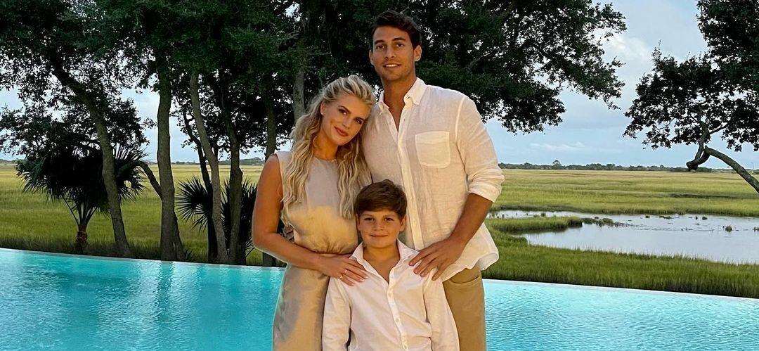 A photo showing Madison LeCroy, her fiancé, Brett, and her son taking a family portrait beside the pool