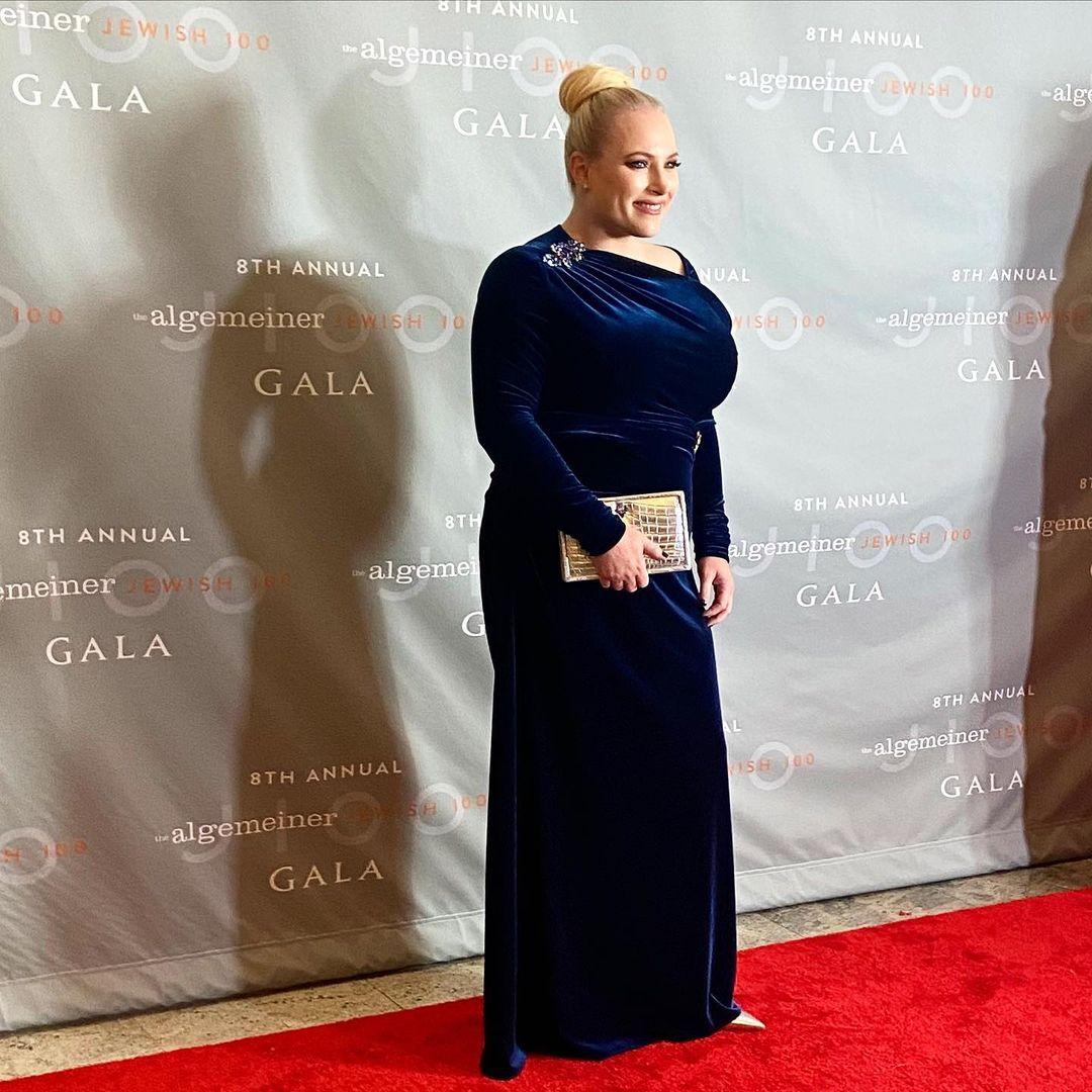 A photo showing Meghan McCain at a red carpet event in a dark blue velvet dress.