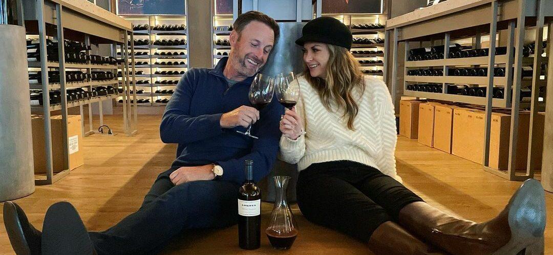 A photo showing Chris Harrison and Lauren Zima clinking a glass of wine.