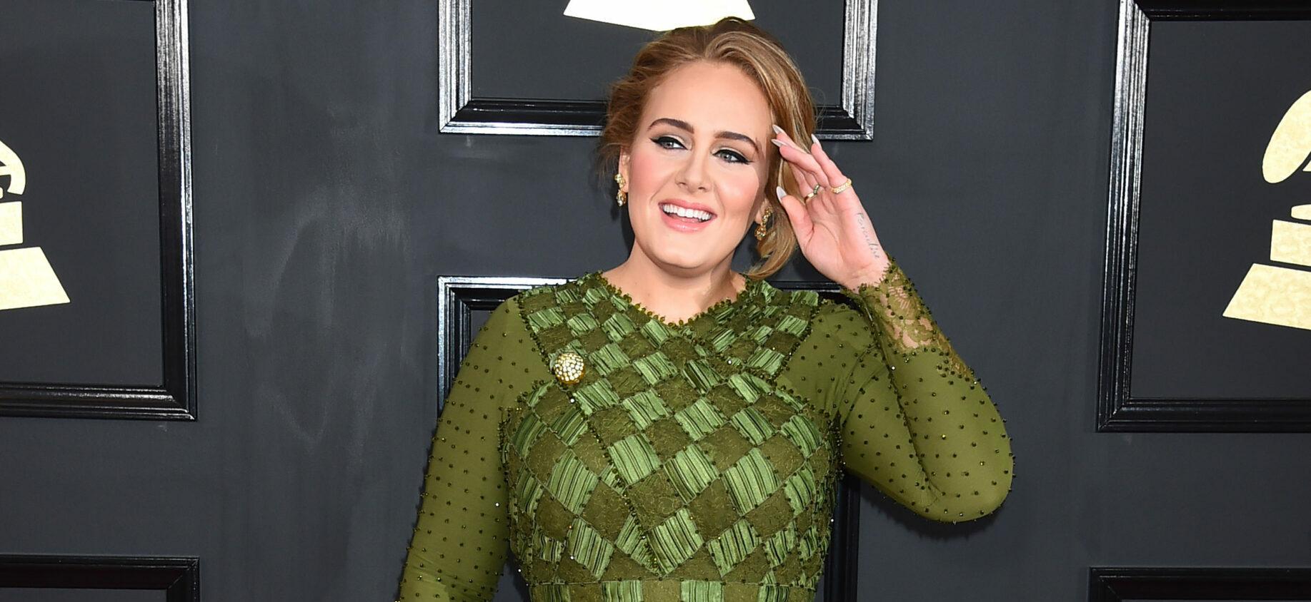 Adele looks incredible in this green dress at a red carpet event.
