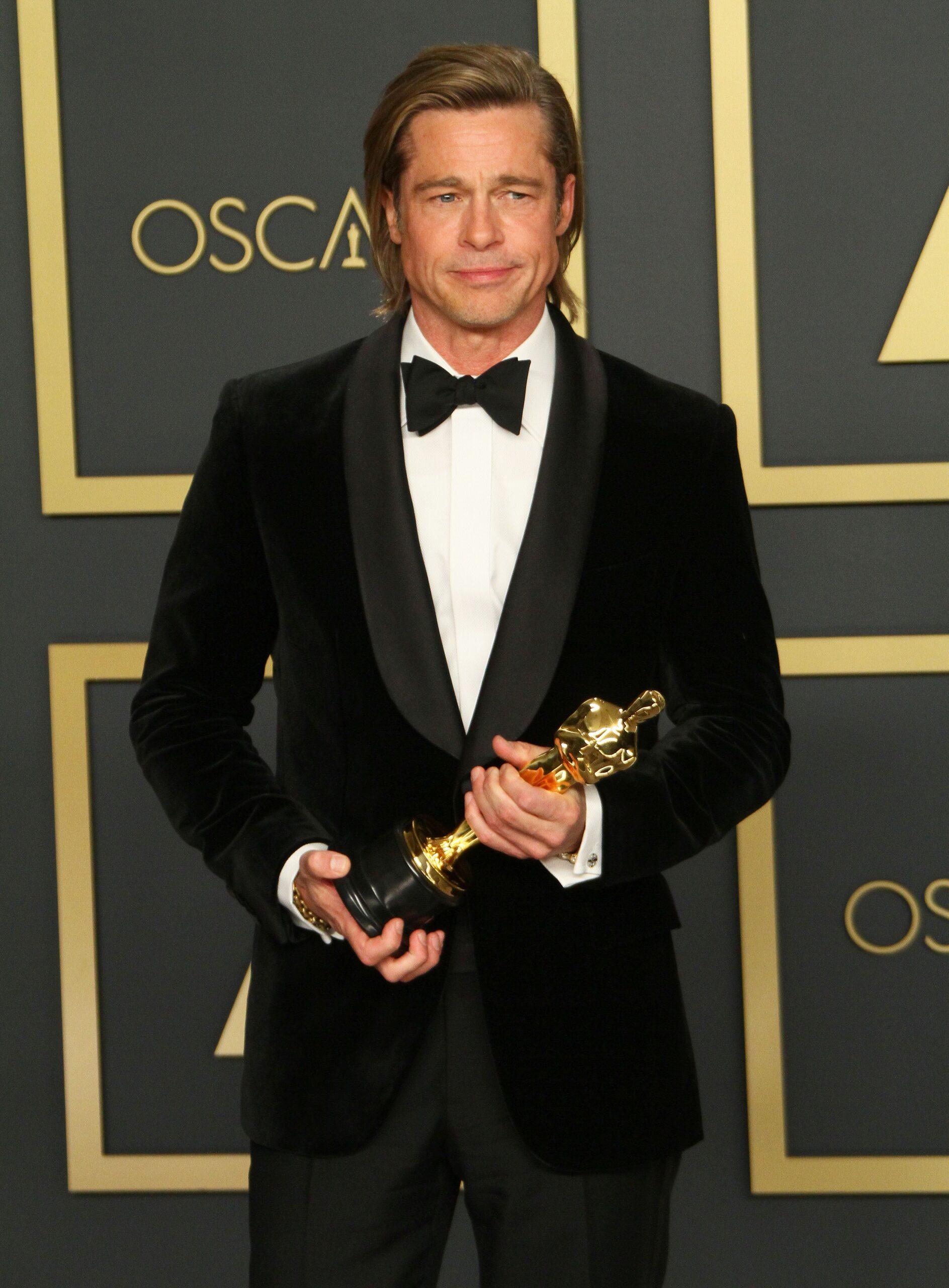 Brad Pitt holding his Oscar