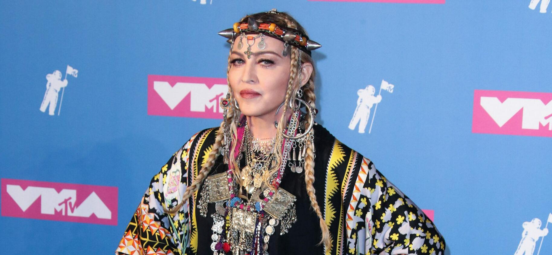 A photo showing Madonna at an event in a traditional outfit.
