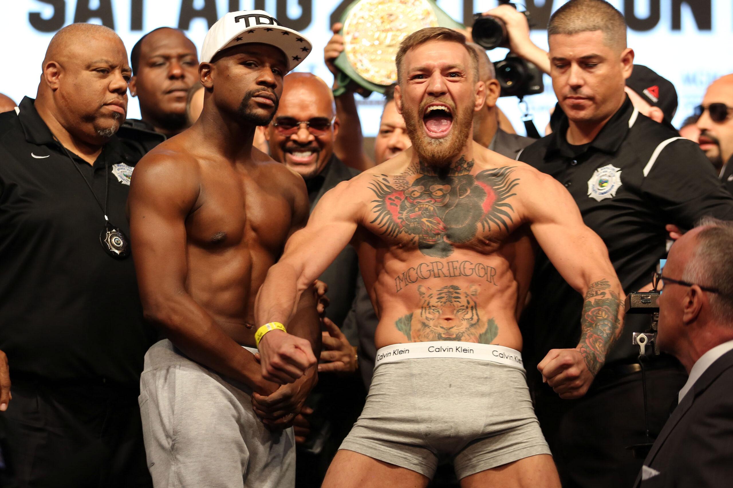 Conor McGregor and Floyd Mayweather weigh in