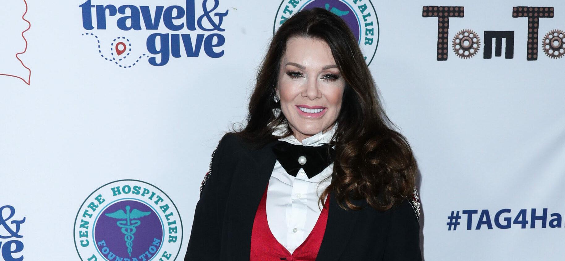A photo showing Lisa Vanderpump sporting a black suit paired with a red and white inner-wear and black bow tie.