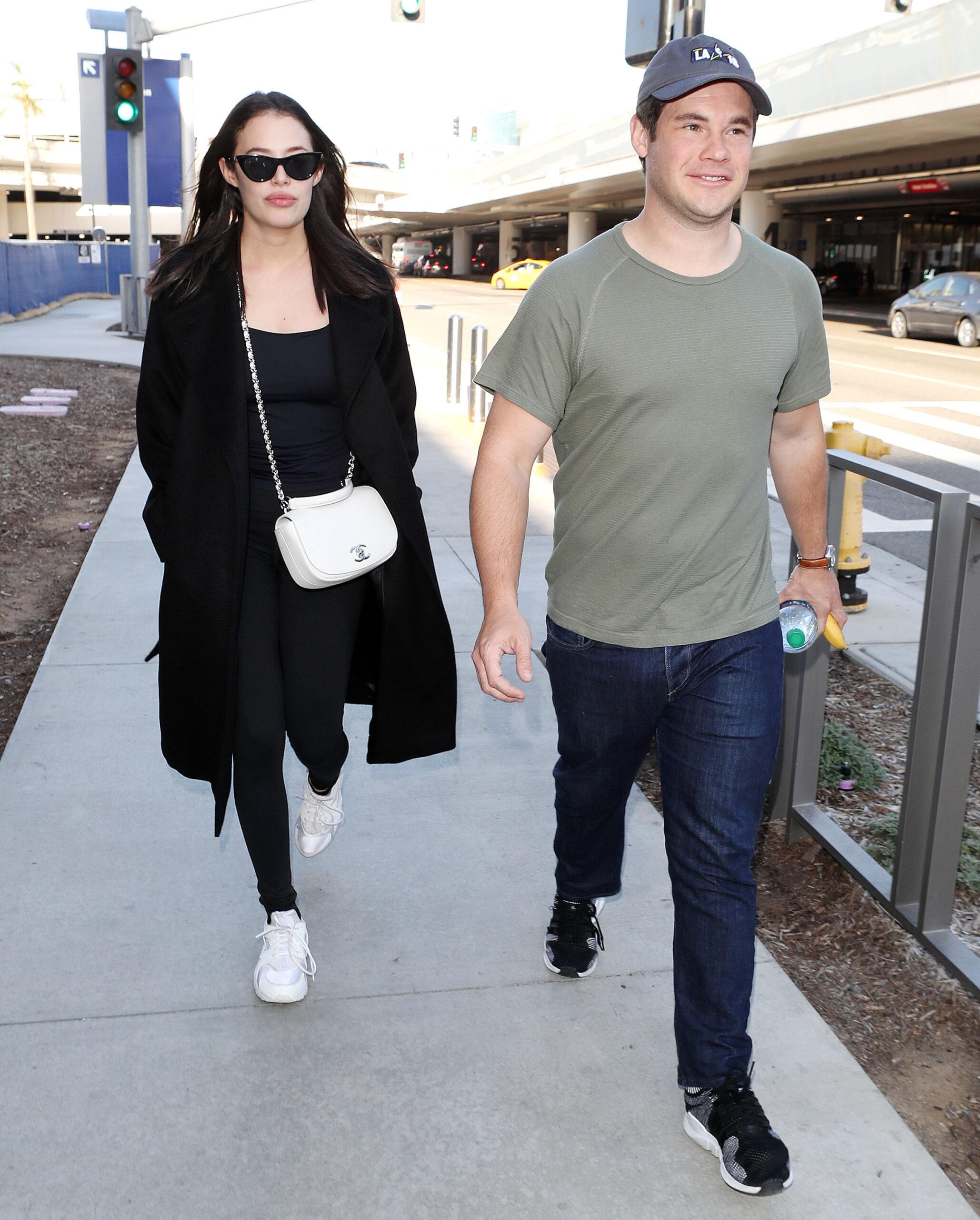 Adam DeVine and Chloe Bridges at the Los Angeles International Airport