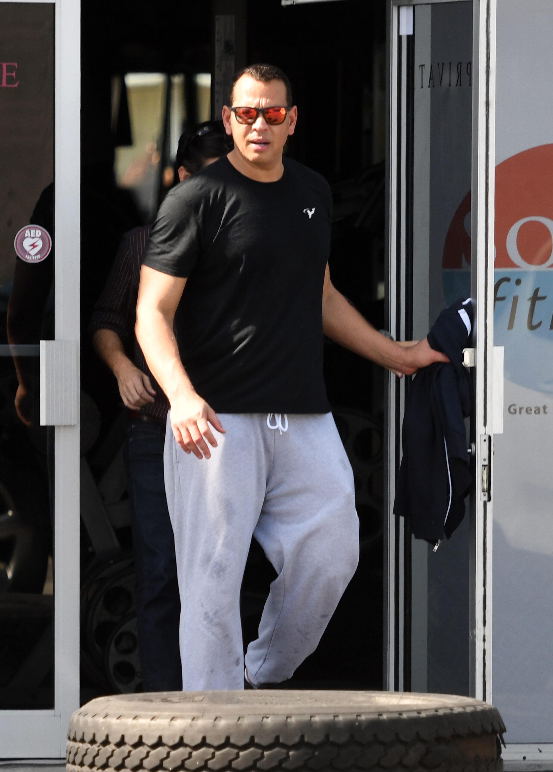 Jennifer Lopez wearing a pink sweat shirt and nude color yoga pants with boyfriend Alex Rodriguez are seen going to gym n Miami