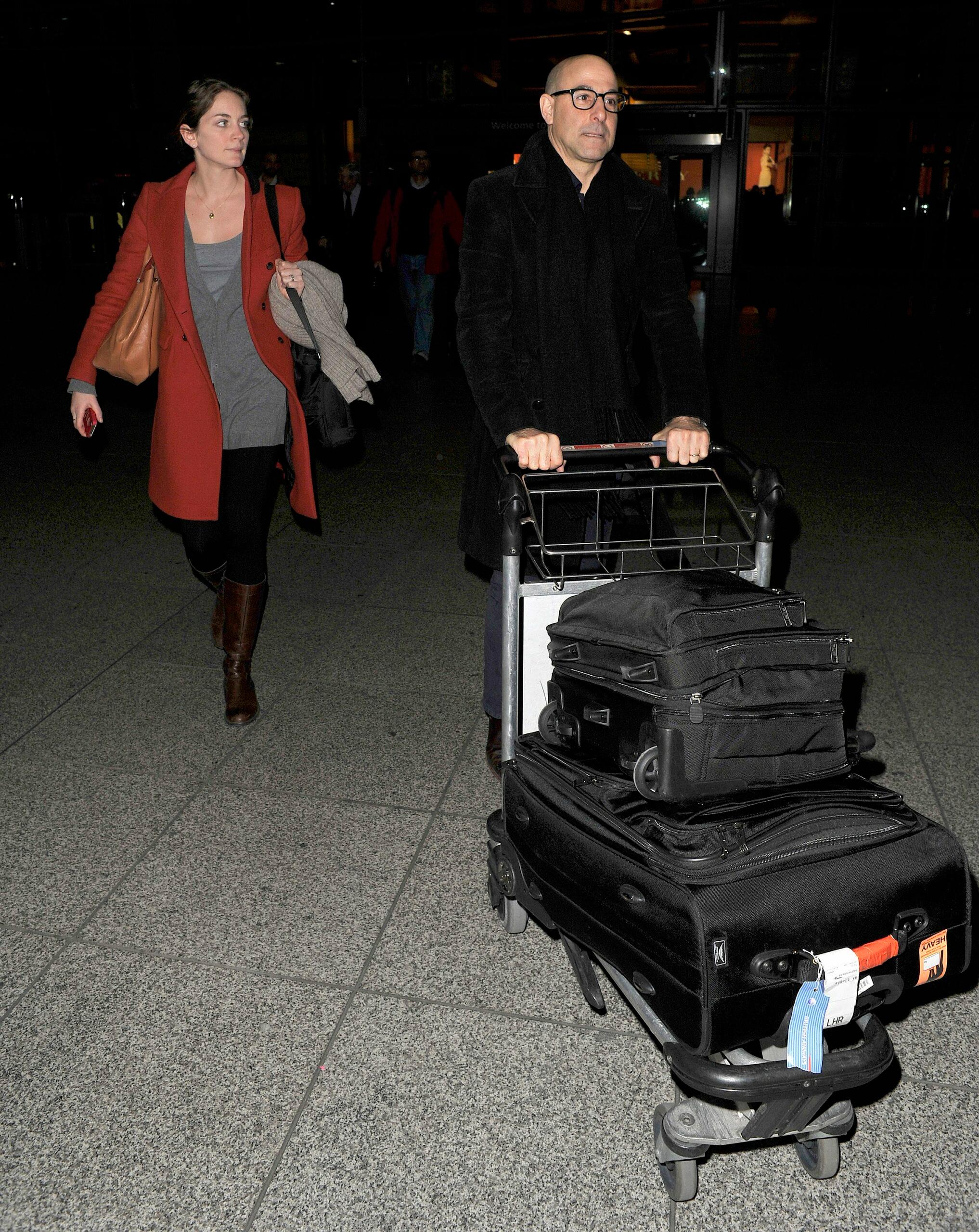 Stanley Tucci and his wife Felicity Blunt arriving into Heathrow Airport