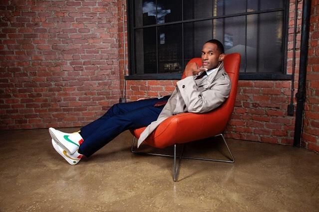 A photo showing Lawrence Saint-Victor sitting on a red sofa.