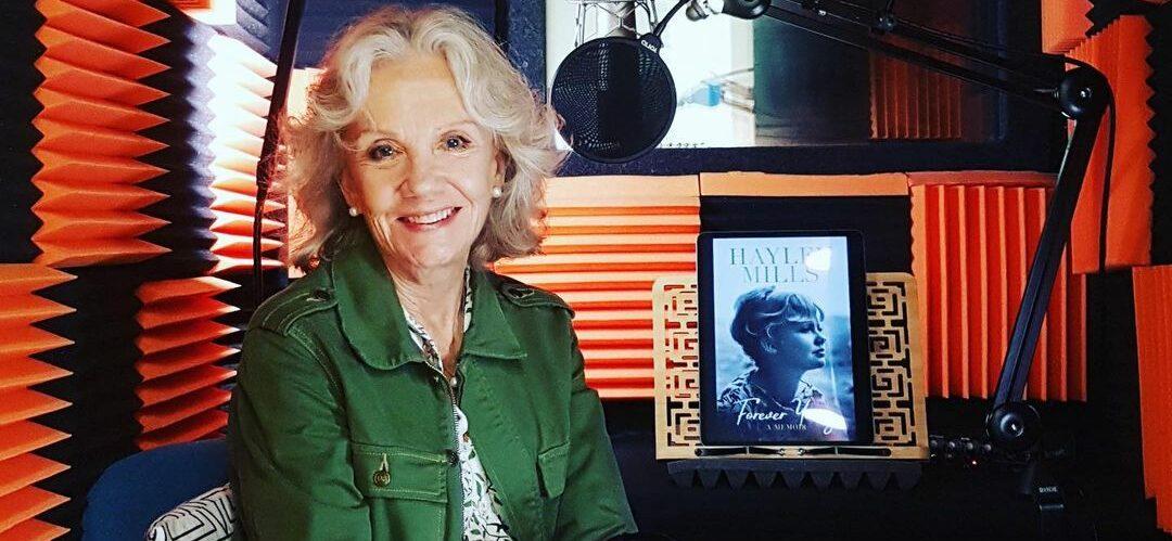 A photo showing Hayley Mills in an interview room, wearing a green jacket.