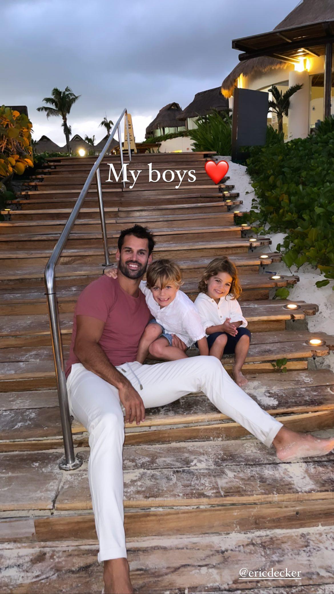 Eric Decker and his sons posing smiling.