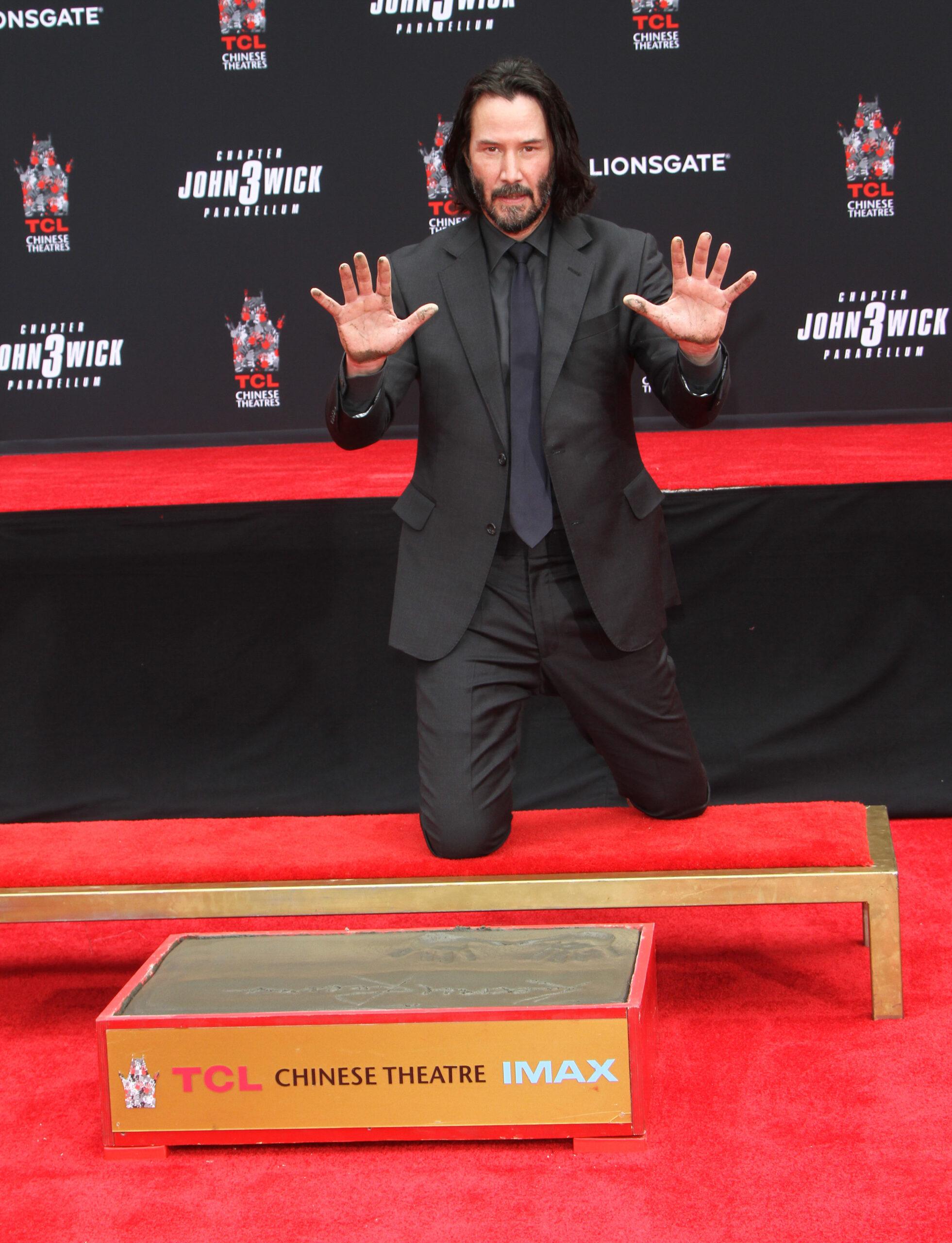 Keanu Reeves hands and footprints in ceremony in cement in Los Angeles