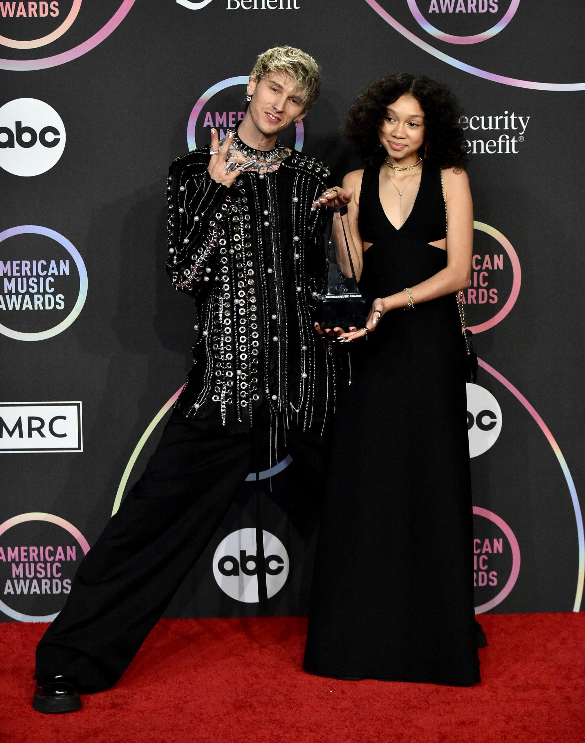 Machine Gun Kelly and daughter pose for the camera.