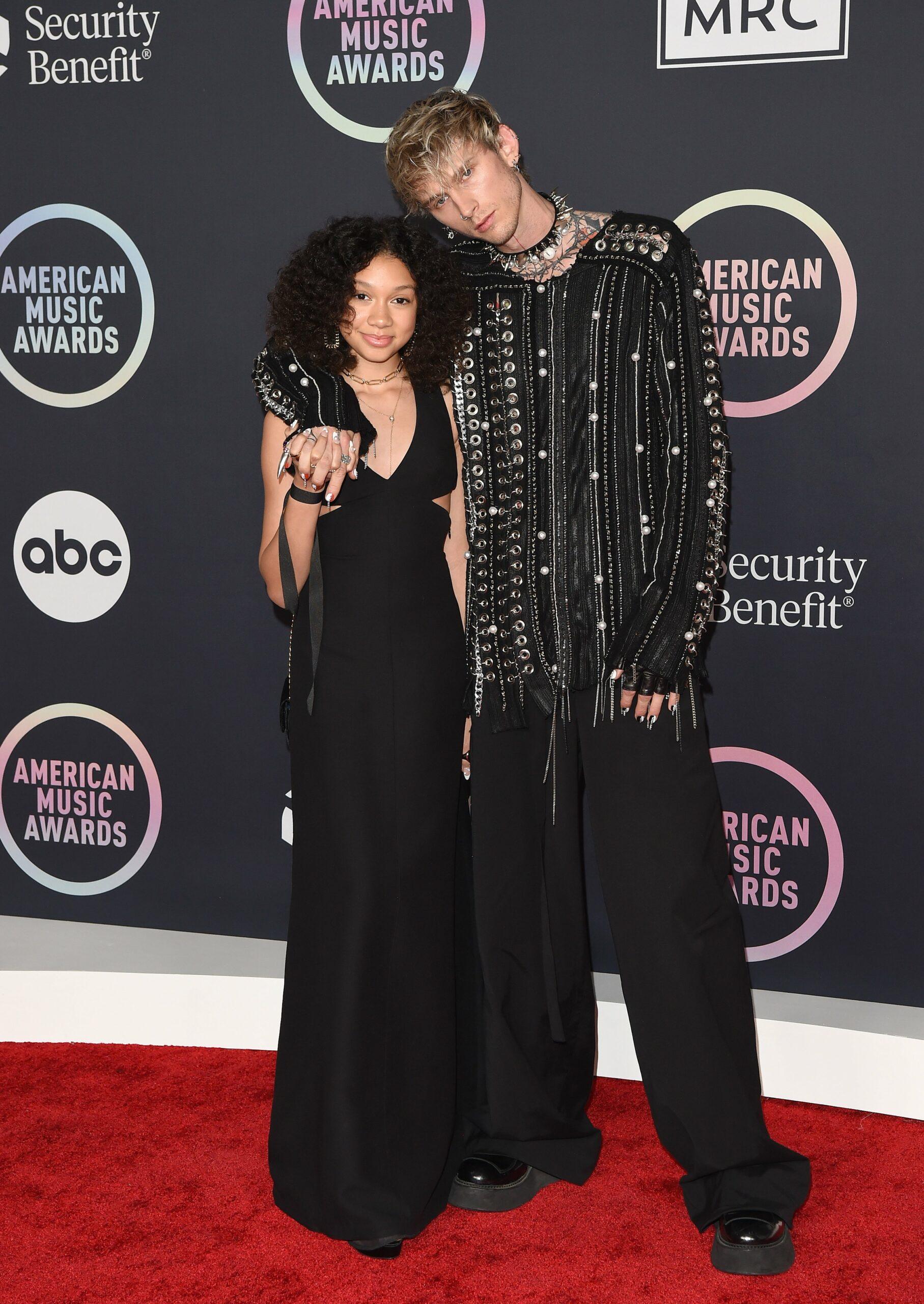 Machine Gun Kelly and daughter pose for the camera.
