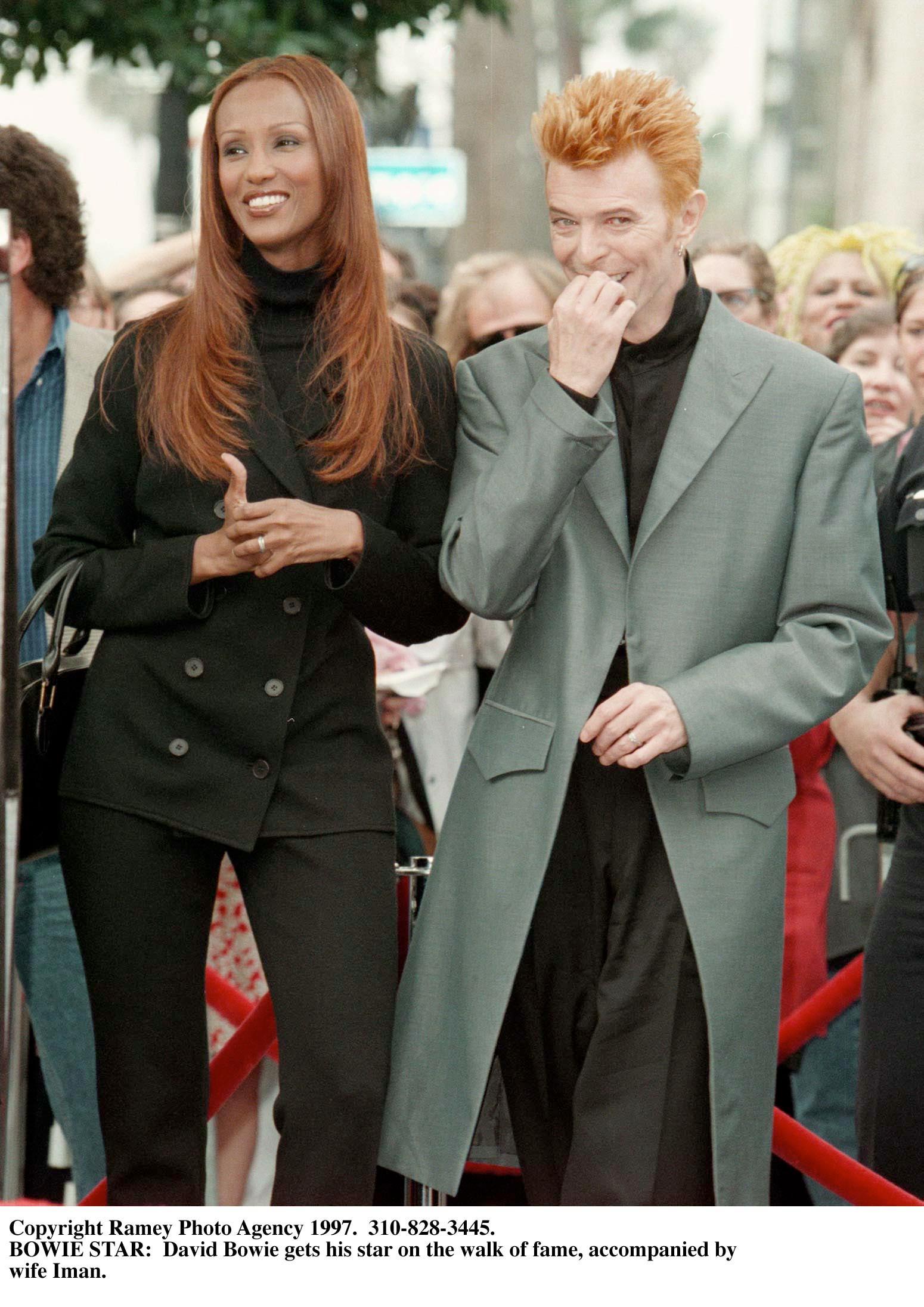 Iman and David Bowie smiling.