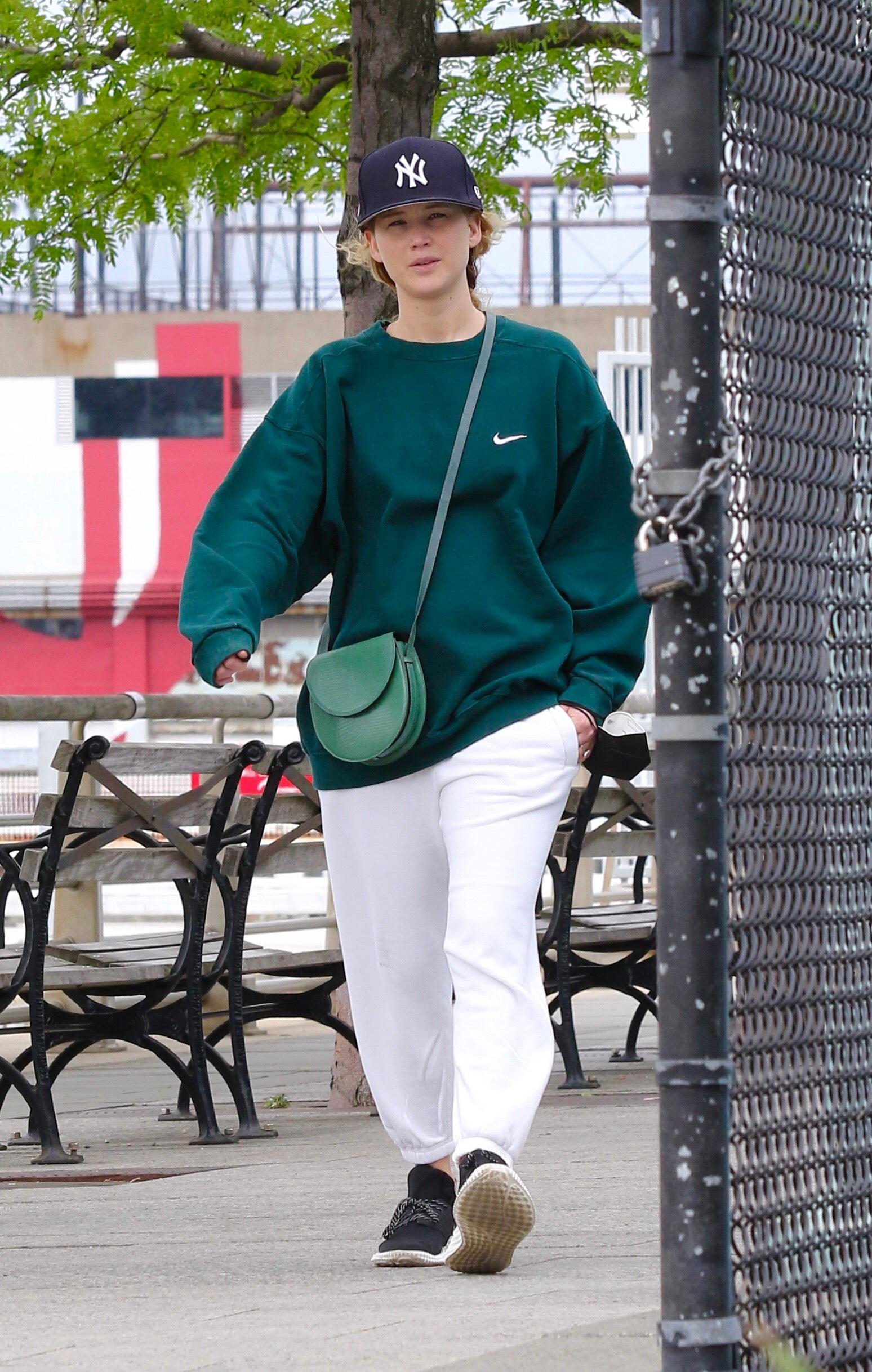 Jennifer Lawrence in sweats goes on a power walk with husband Cooke Maroney in Hudson River Park NYC