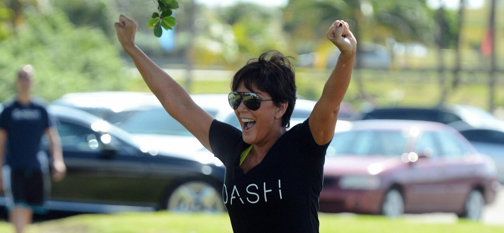 Kris Jenner celebrating with her hands up in the air