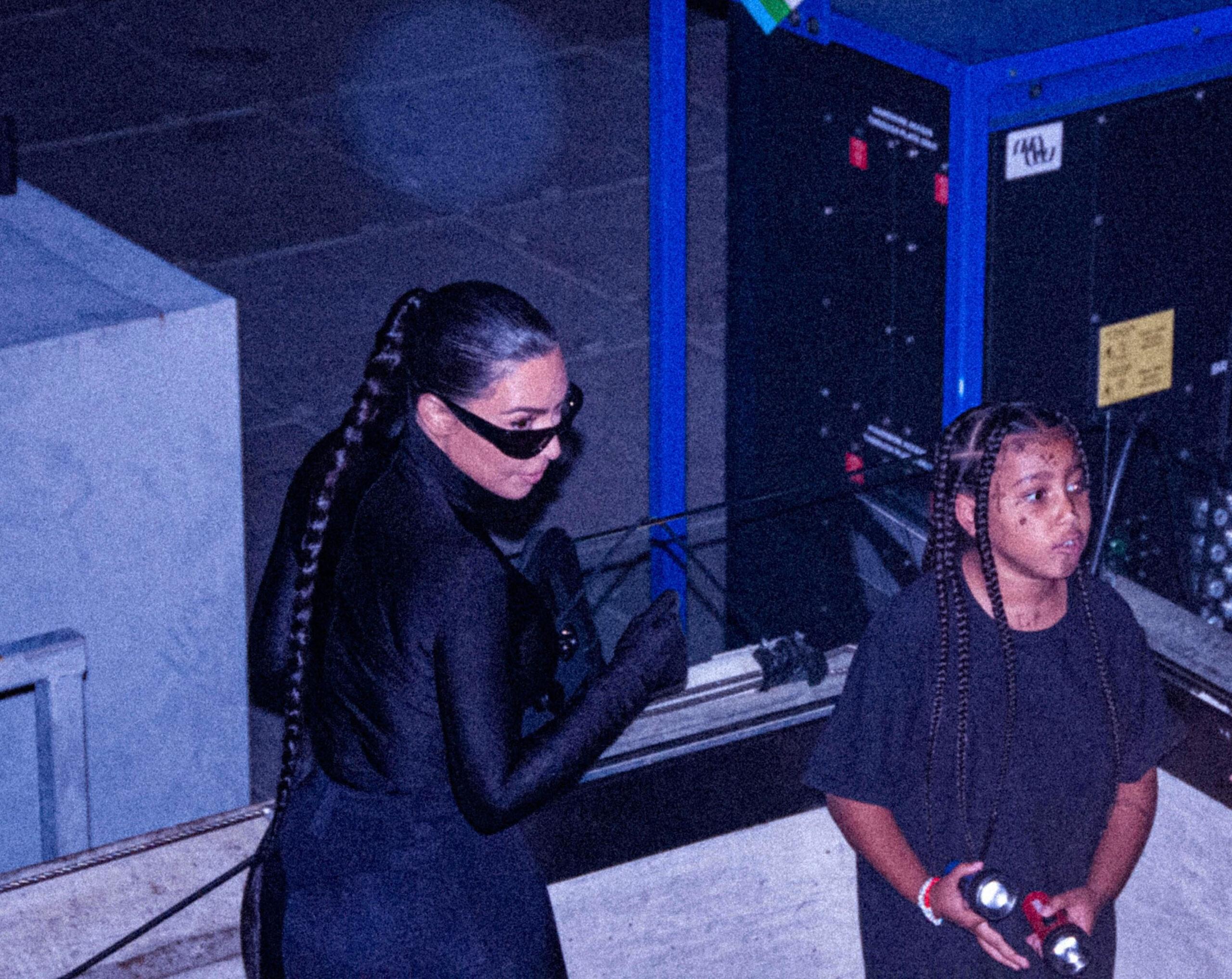 Kim Kardashian and her children show their support for Kanye West at his album launch party in Atlanta. The reality superstar stunned in a figure-hugging black Balenciaga outift matching Kanye’s as she watched him host his second release party for “Donda” at the Mercedes-Benz Stadium on August 5. Kim was briefly spotted without her designer sunglasses, while daughter North West had what appeared to be tattoo-style transfers on her face as she cheered on her dad with siblings Saint, Chicago and Psalm. 05 Aug 2021 Pictured: Kim Kardashian and North West at Kanye West's second "Donda" album release party at Mercedes-Benz Stadium in Atlanta. Photo credit: Sam Johnston/MEGA TheMegaAgency.com +1 888 505 6342 (Mega Agency TagID: MEGA776977_001.jpg) [Photo via Mega Agency]