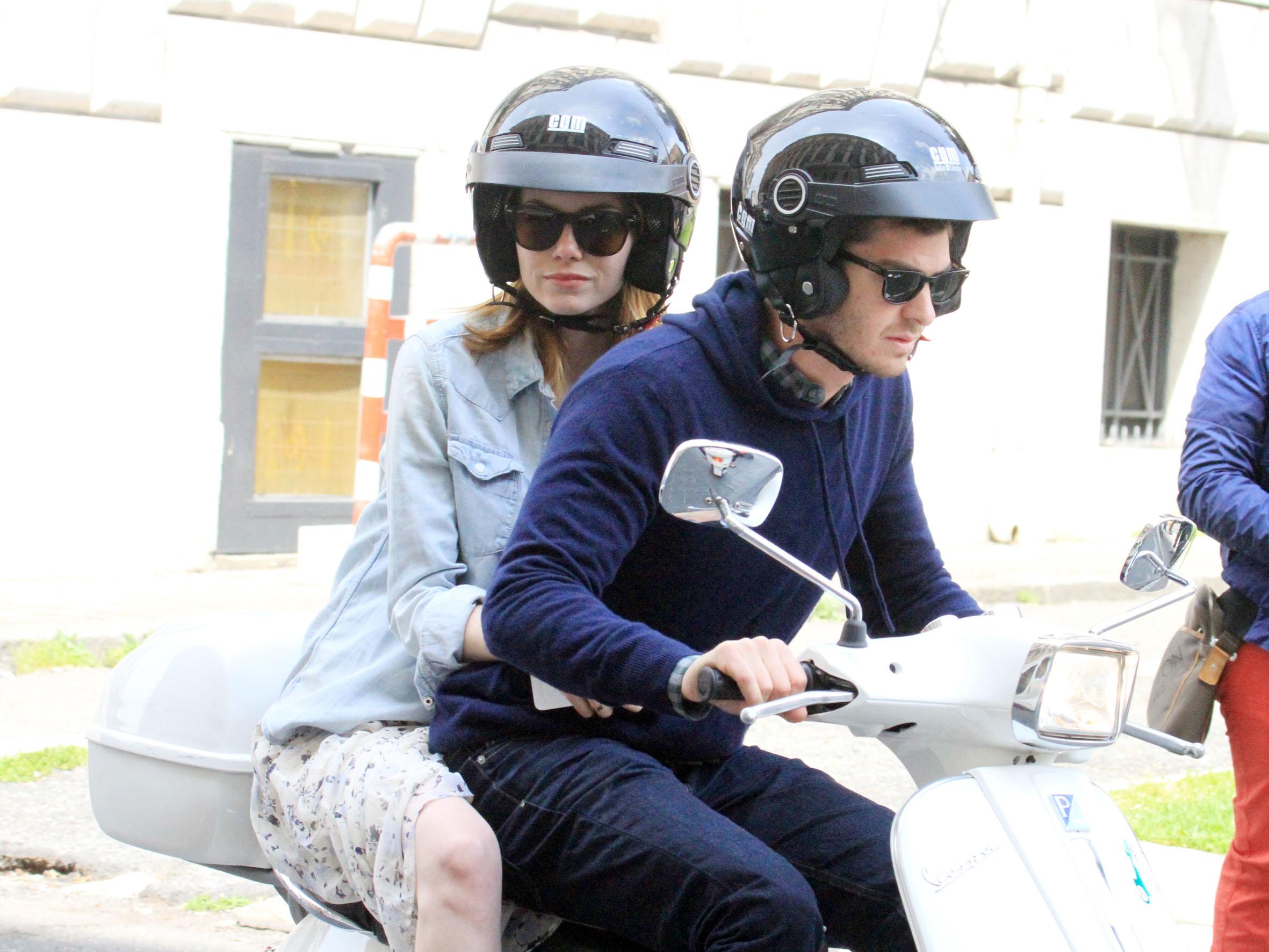 Emma Stone and Andrew Garfield riding a motorcycle.