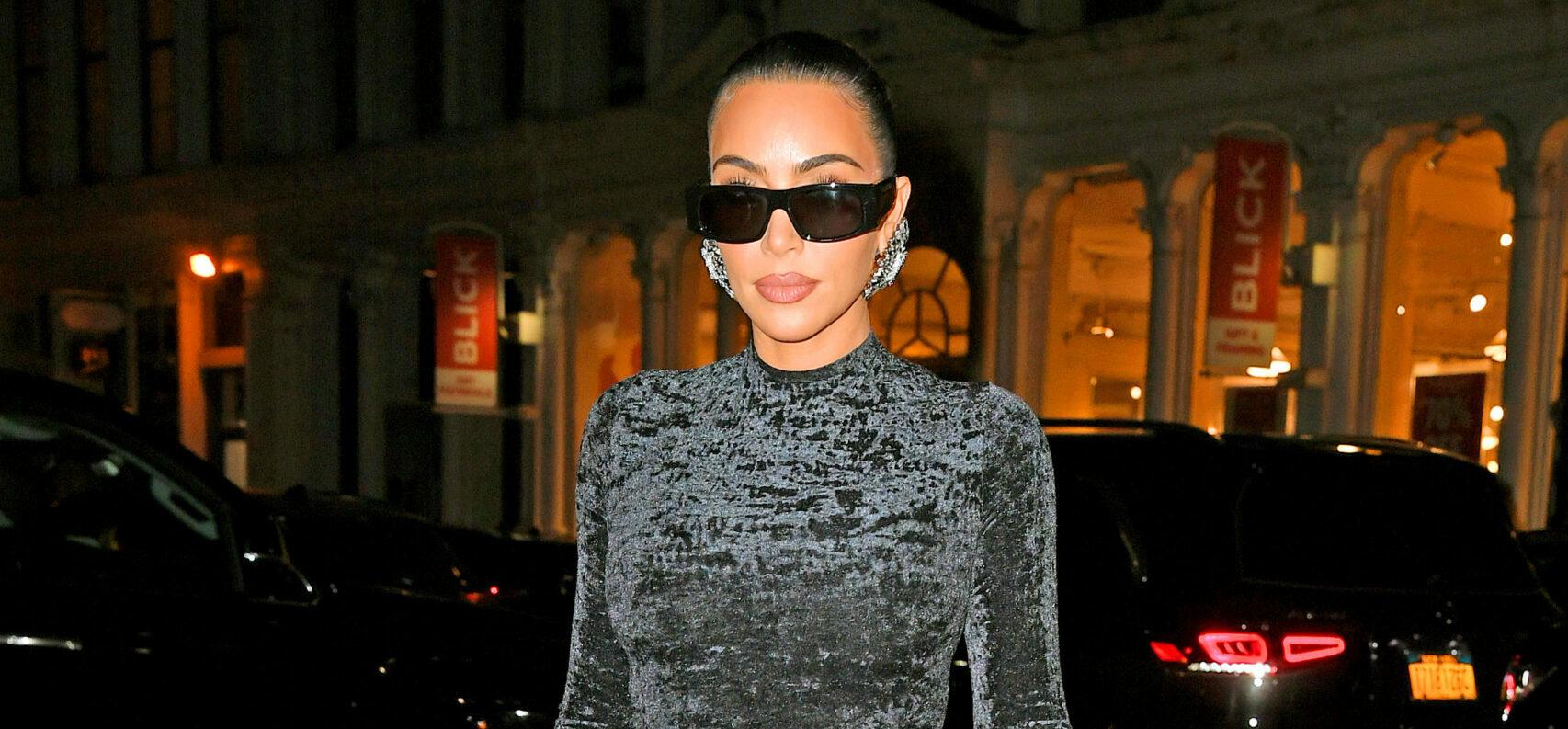 Kim Kardashian shows off her famous curves in a black dress