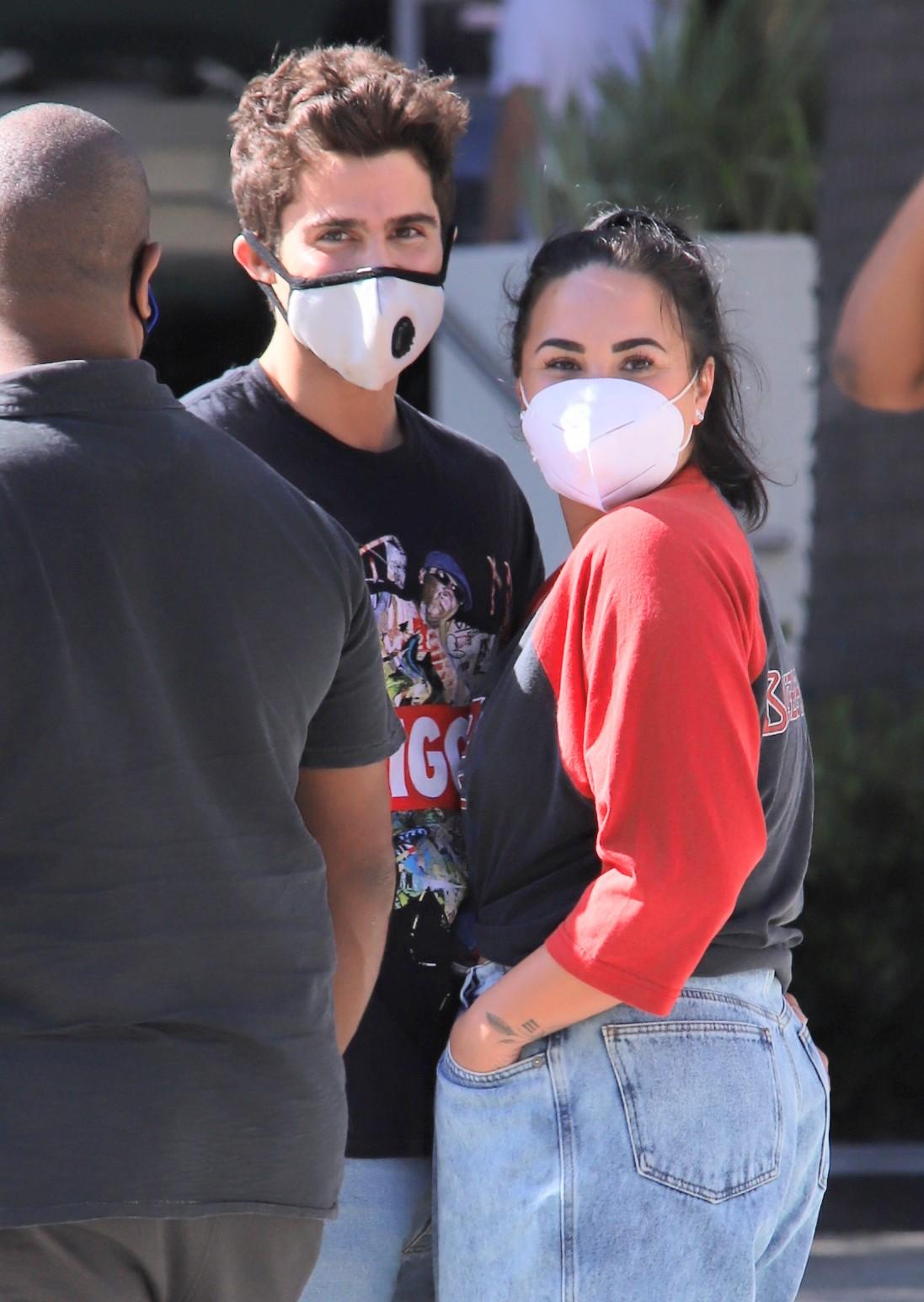 Demi Lovato & Max Ehrich wearing masks