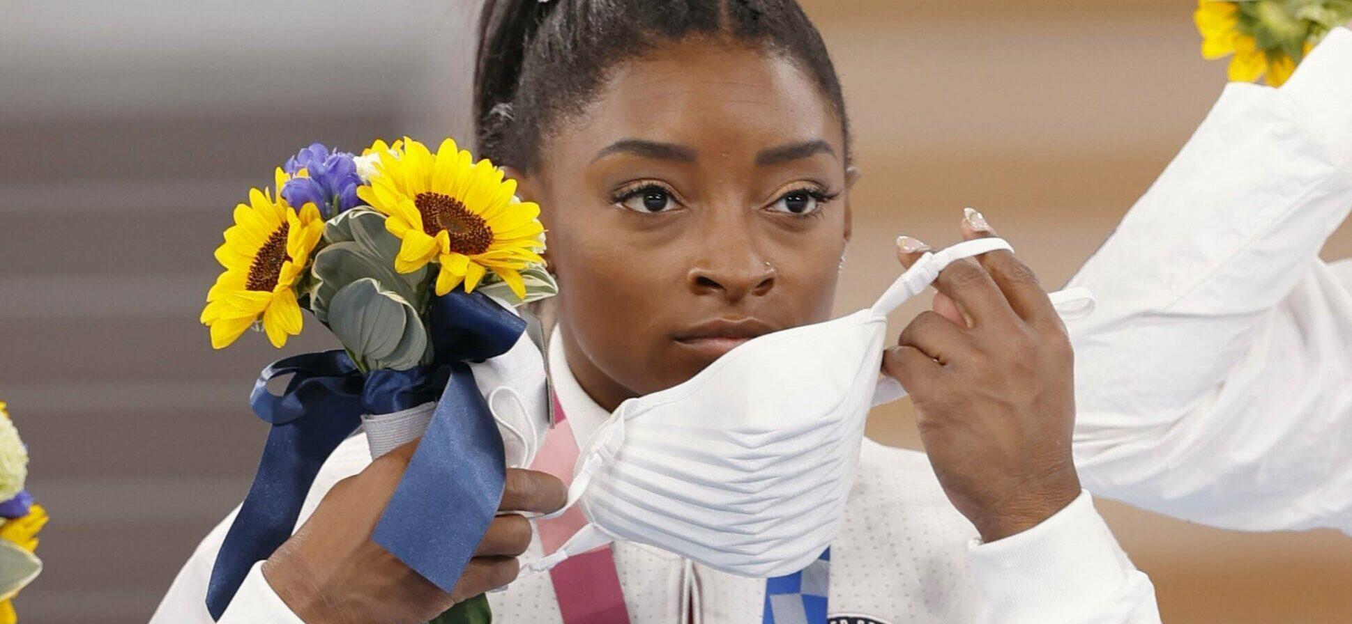 Simone Biles of the United States puts on a mask for protection against the coronavirus after photo shoots during the medal ceremony of the Tokyo Olympic women's artistic gymnastics team competition on July 27, 2021, at Ariake Gymnastics Centre. The United States took silver. (Kyodo)==Kyodo Newscom/(Mega Agency TagID: kyodowc295990.jpg) [Photo via Mega Agency]