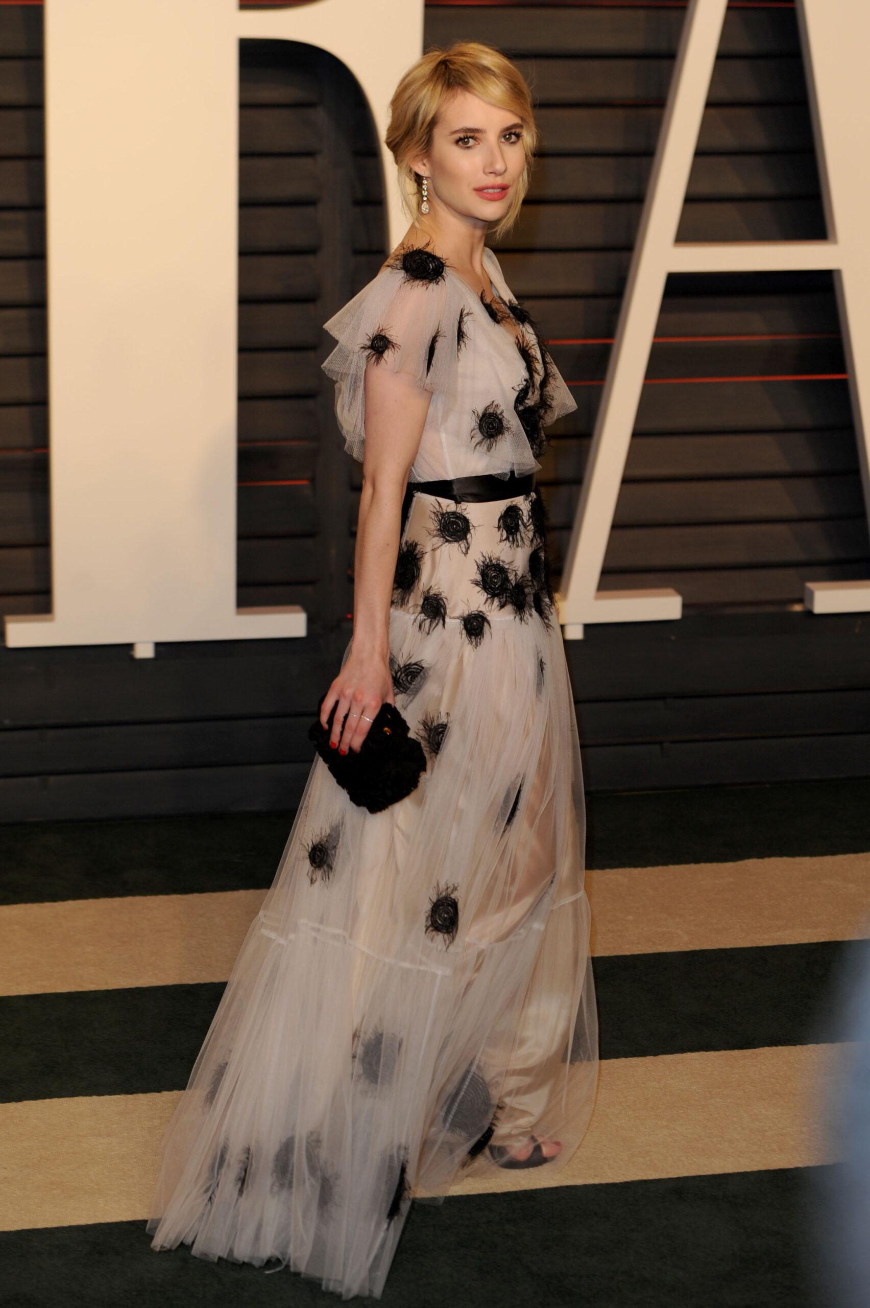 Emma Roberts poses on the red carpet at the Vanity Fair Oscar Party in LA
