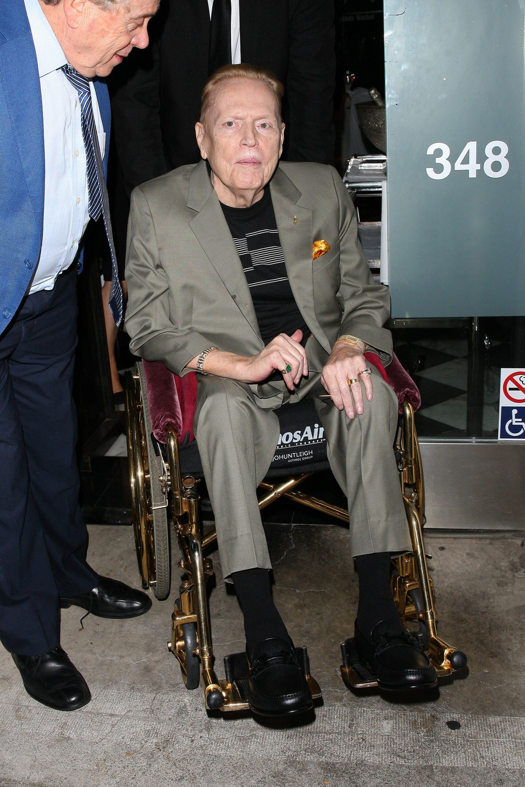 Larry Flynt gets a helping hand from his care taker as he is seen leaving Mr Chow restaurant