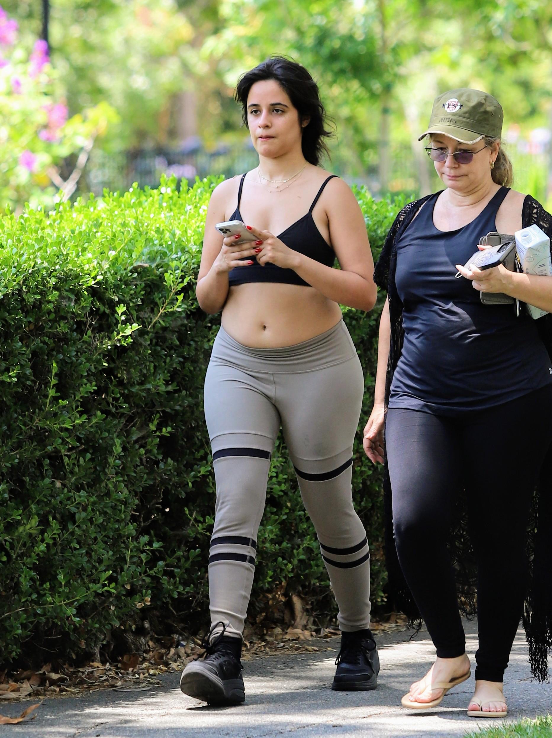 Camila Cabello seen getting excessive with her mother at the park in leggings and crop top. 16 Jul 2021 Pictured: Camila Cabello. Photo credit: APEX / MEGA TheMegaAgency.com +1 888 505 6342 (Mega Agency TagID: MEGA771689_001.jpg) [Photo via Mega Agency]